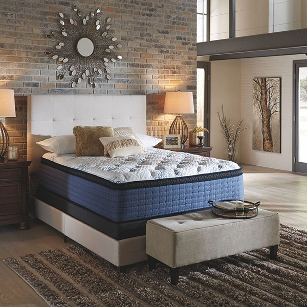 Beautiful white and blue mattress in a empty bedroom